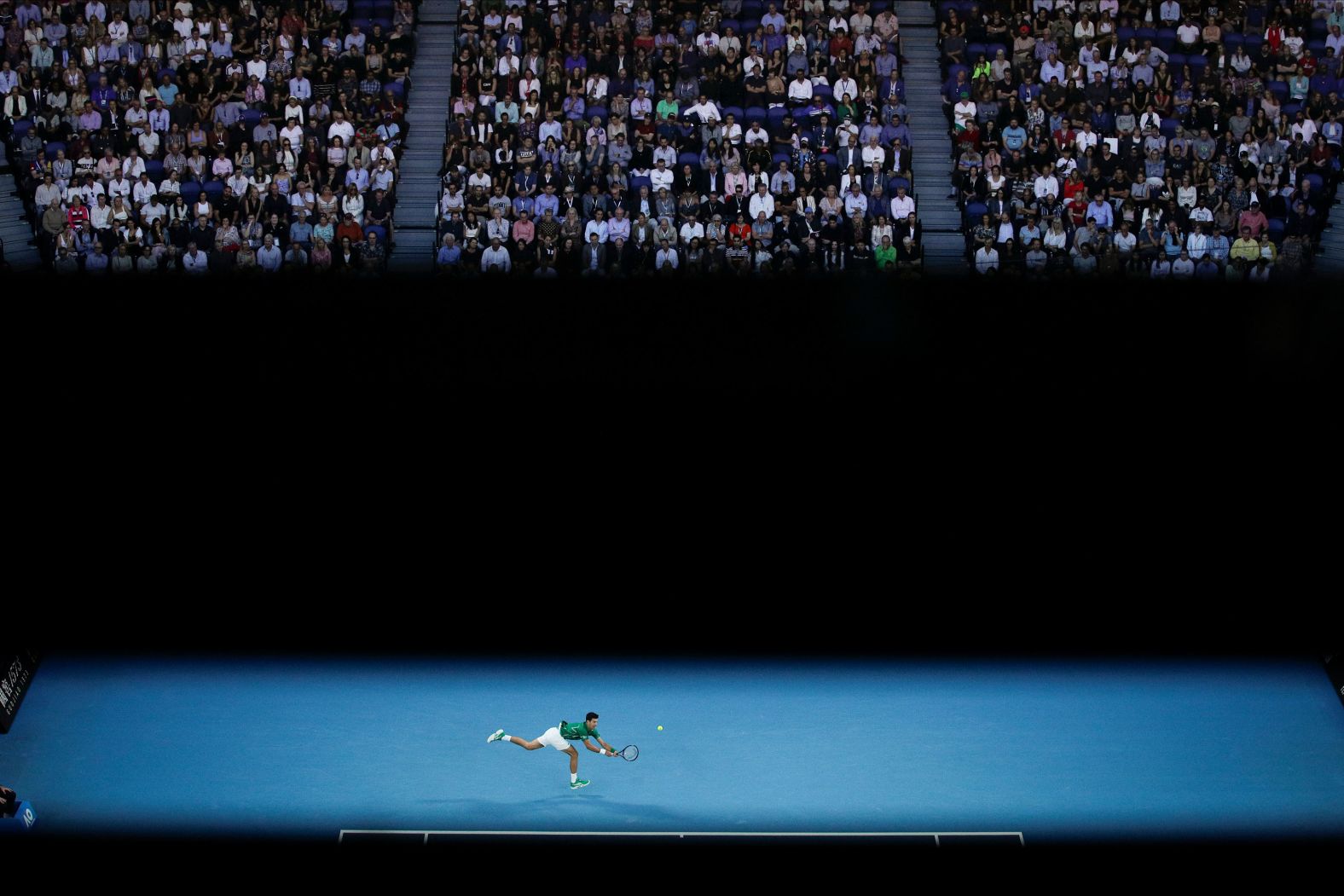 Djokovic makes a backhand return.
