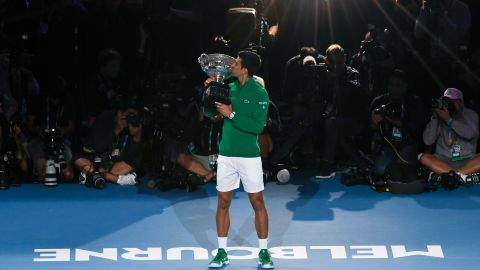 Novak Djokovic kisses the trophy after winning the Australian Open. 