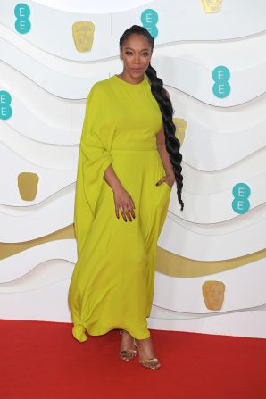 Naomi Ackie wears an elegant lime green dress by Valentino.