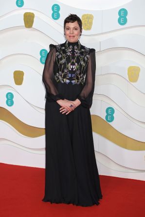 Olivia Colman wears an embroidered black silk creponne dress by Alexander McQueen.