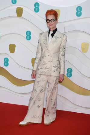 British costume designer Sandy Powell had stars sign her pantsuit, which she reportedly intends to auction off.
