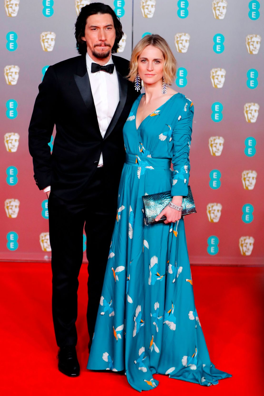 Adam Driver wearing a  Celine suit and his wife Joanne Tucker. 