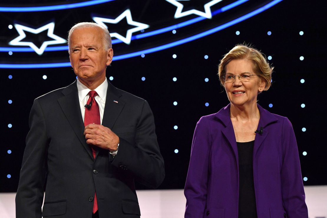Biden and Warren arrive onstage for the fourth Democratic primary debate of the 2020 presidential campaign season co-hosted by The New York Times and CNN at Otterbein University in Westerville, Ohio on October 15, 2019. 