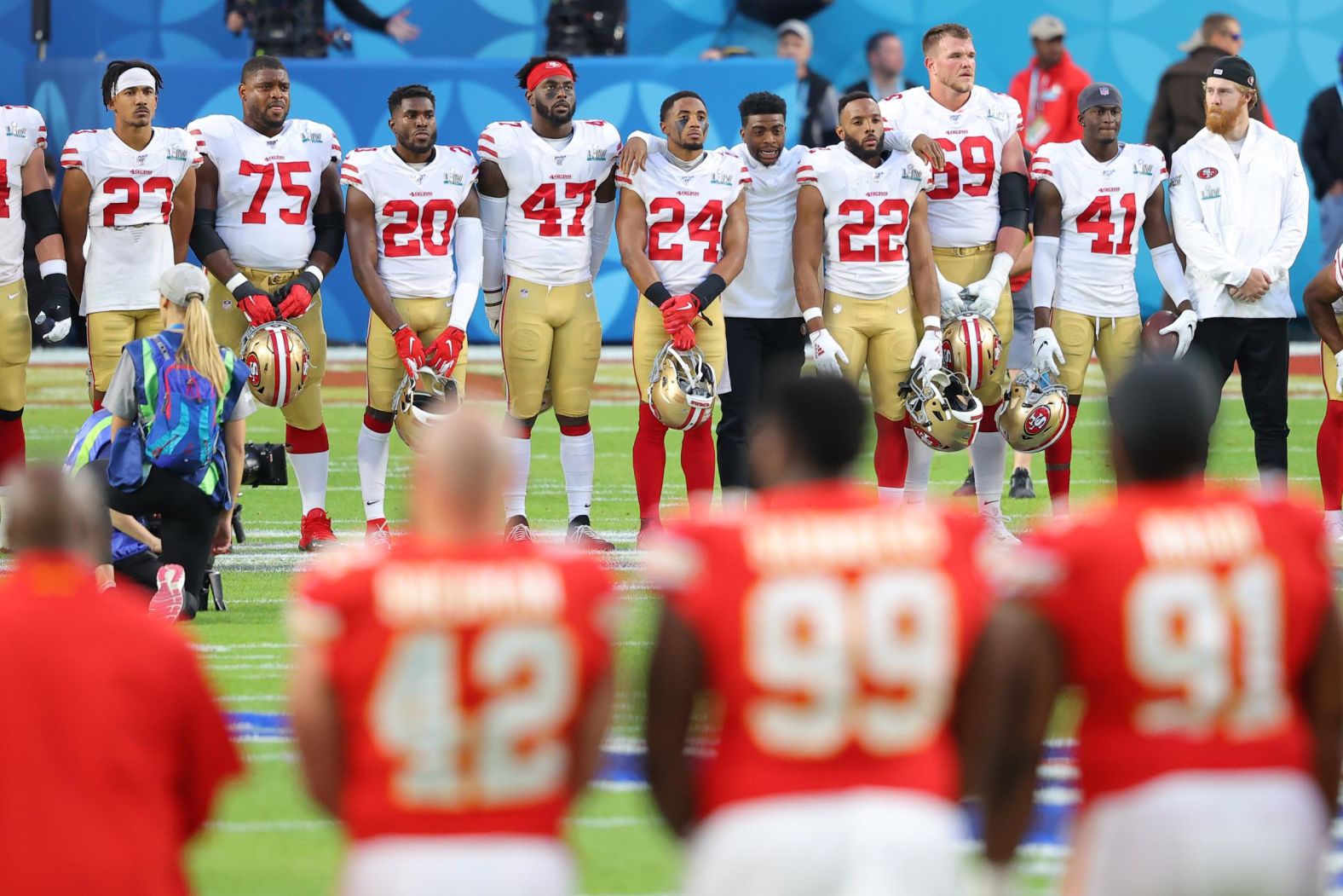 Both teams stand on the 24-yard lines before the game to observe a moment of silence for NBA legend Kobe Bryant, Bryant's daughter Gianna and other people who died in a helicopter crash last week.