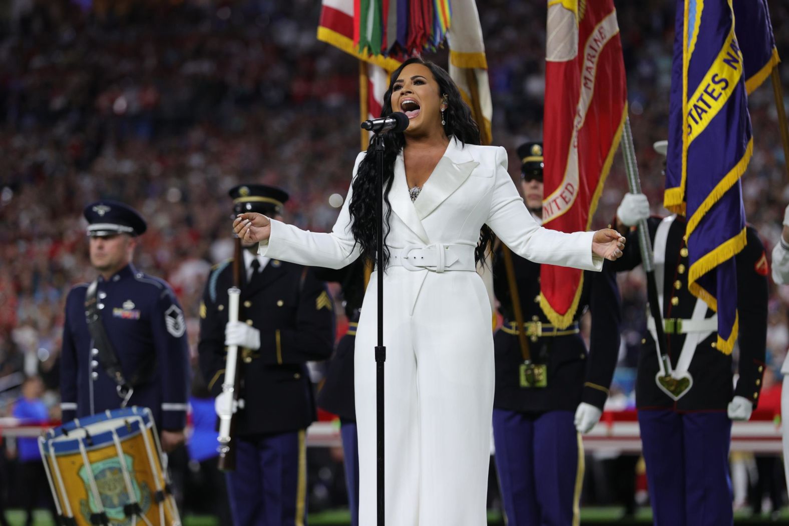 Singer Demi Lovato performs the National Anthem before the game.