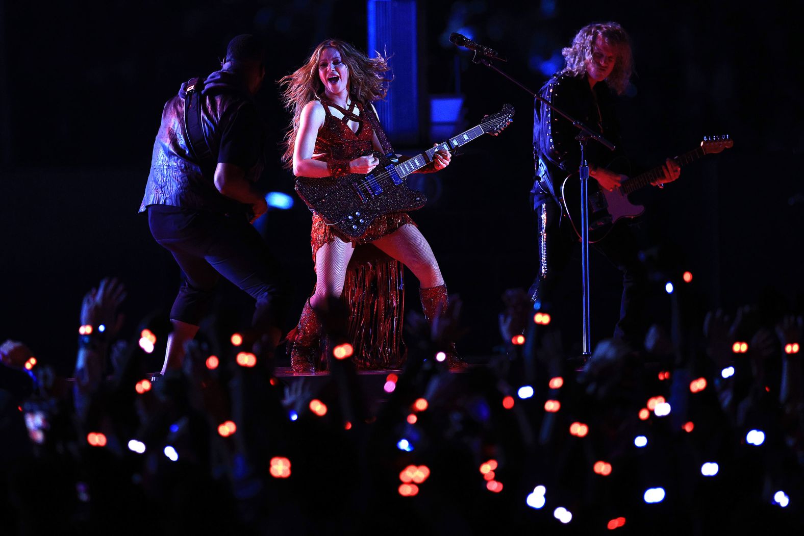 Shakira plays the guitar. Her songs included "She Wolf," "Hips Don't Lie" and "Whenever, Wherever."