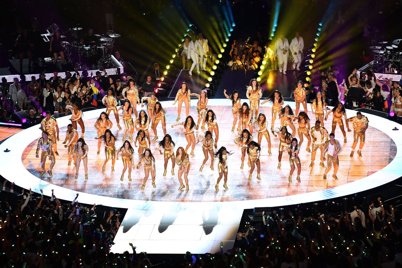 Shakira and dancers appear on stage.