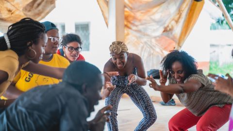 Scholars dancing with a professor from the University of Ghana's Performing Arts School in Accra, Ghana in 2018.