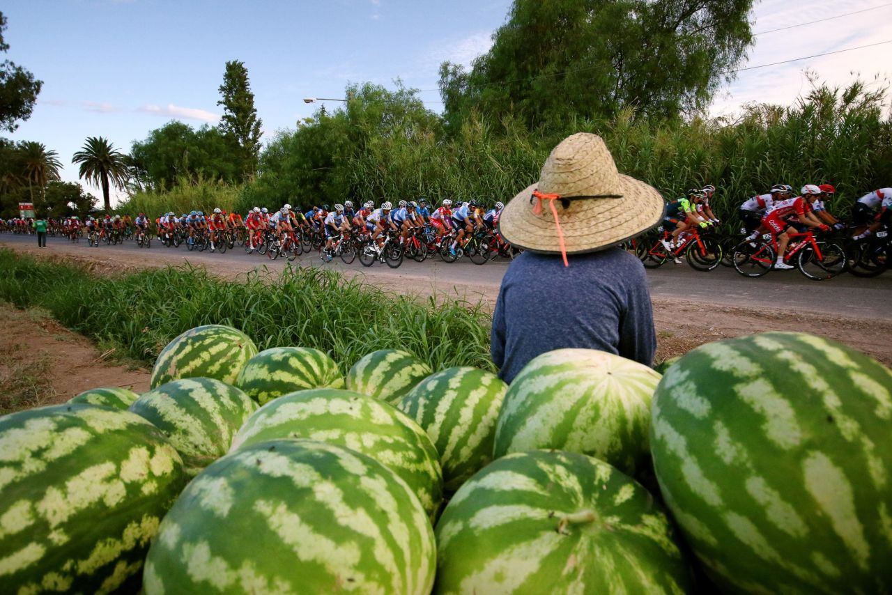 Cyclists race past melons in Pocito, Argentina, on Monday, February 27.