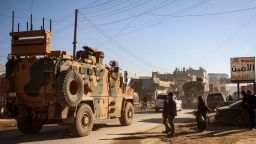 A Turkish military convoy of tanks and armoured vehicles passes through the Syrian town of Dana, east of the Turkish-Syrian border in the northwestern Syrian Idlib province, on February 2, 2020.