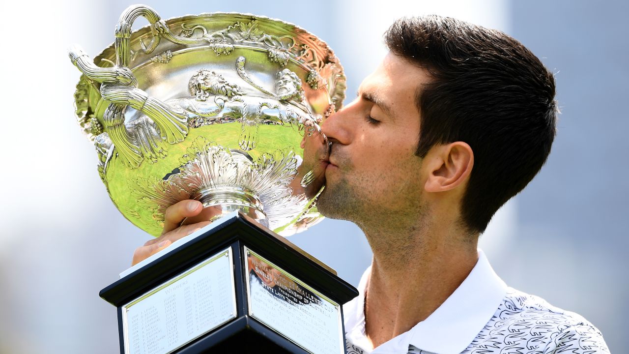 Djokovic poses with the trophy following his 2020 Australian Open victory.