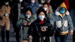 Travelers wearing facemasks arrive from various provinces at the Beijing Railway Station on February 3, 2020. - China said February 3 it urgently needed medical equipment and surgical masks as the death toll from a new coronavirus jumped above 360, making it more deadly than the SARS crisis nearly two decades ago. (Photo by NOEL CELIS/AFP via Getty Images)