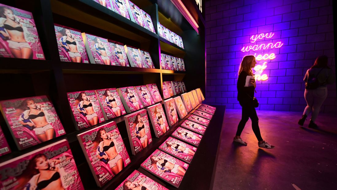 <strong>Rolling Stone:</strong> A woman walks past a display with images of Rolling Stone magazine at "The Zone," a pop-up experience and retail store celebrating the peak of Britney Spears' musical career.