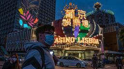 MACAU, CHINA - JANUARY 28: People wearing face masks walk in front of the Grand Lisboa Hotel on January 28, 2020 in Macau, China. The number of cases of a deadly new coronavirus rose to over 4000 in mainland China Tuesday as health officials locked down the city of Wuhan last week in an effort to contain the spread of the pneumonia-like disease which medicals experts have confirmed can be passed from human to human. In an unprecedented move, Chinese authorities put travel restrictions on the city which is the epicentre of the virus and neighbouring municipalities affecting tens of millions of people.  At least six people have reportedly contracted the virus in Macau. The number of those who have died from the virus in China climbed to over 100 on Tuesday and cases have been reported in other countries including the United States, Canada, Australia, France, Thailand, Japan, Taiwan and South Korea.  (Photo by Anthony Kwan/Getty Images)