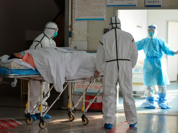 Medical workers move a coronavirus patient into an isolation ward at the Second People's Hospital in Fuyang, China, on February 1, 2020.