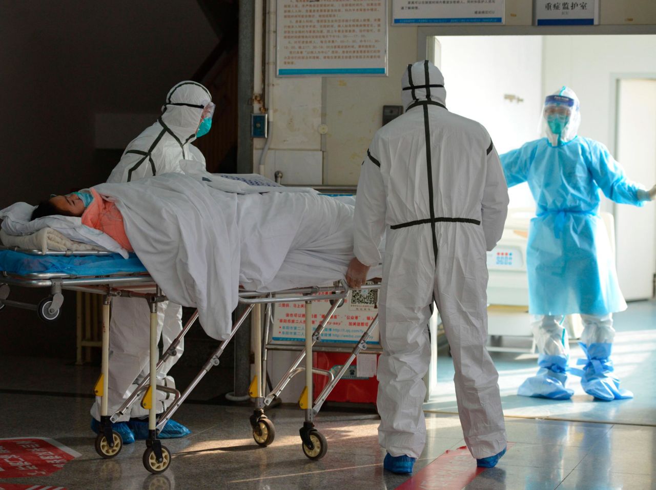 Medical workers move a coronavirus patient into an isolation ward at the Second People's Hospital in Fuyang, China, on February 1.