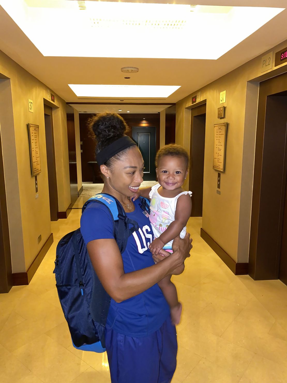 Six-time Olympic gold medalist Allyson Felix holds her daughter, Camryn.