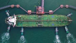 This aerial photo taken on August 4, 2019 shows tugboats berthing an oil tanker at Qingdao port in Qingdao in China's eastern Shandong province. - China's good shipments abroad beat expectations to rise in July while its purchases continued to shrink, official data showed on August 8. (Photo by STR/AFP/Getty Images)