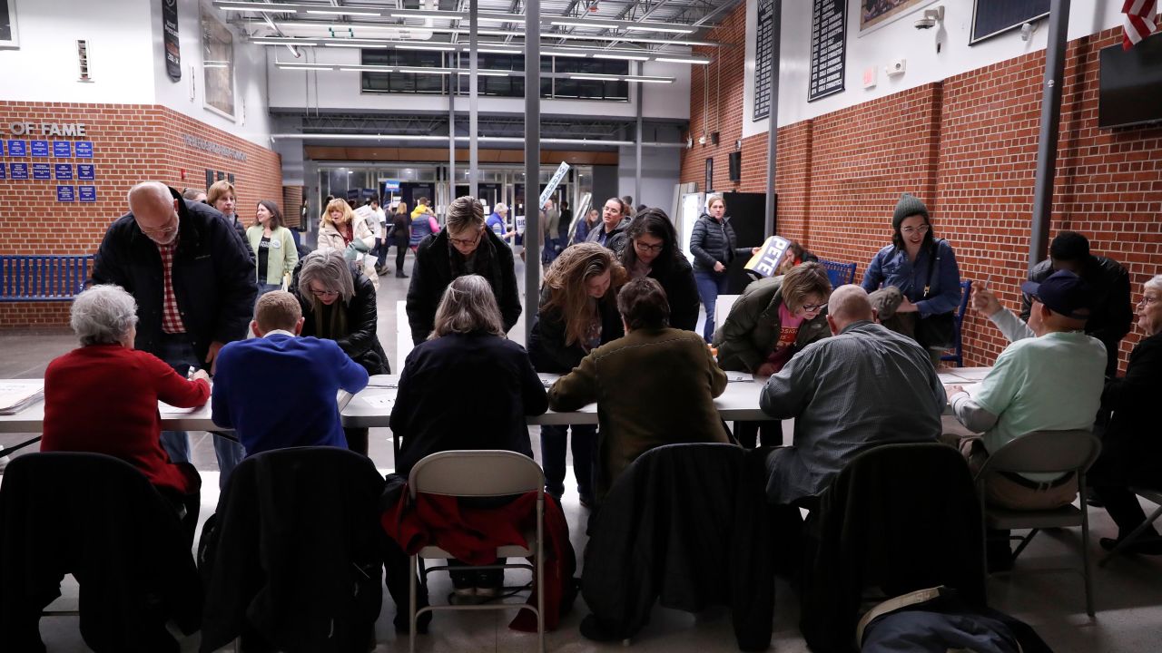 Caucus goers check in before Democratic presidential candidate Sen. Elizabeth Warren, D-Mass., speaks at a caucus at Roosevelt Hight School, Monday, Feb. 3, 2020, in Des Moines, Iowa.