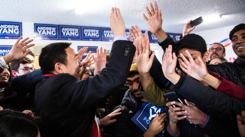 Andrew Yang high-fives supporters at a canvass launch in Iowa City, Iowa, on February 3.