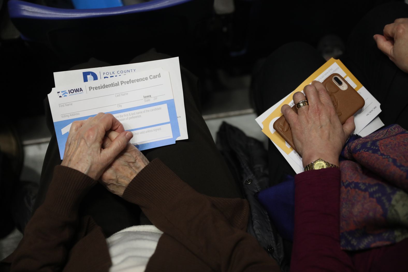 Caucus participants hold presidential preference cards in Des Moines.