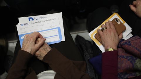 Caucus participants hold presidential preference cards in Des Moines.