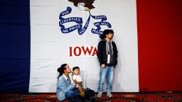 Natalie Serrano, left, and Isaac Garcia watch caucus returns come in with their son Leonel, 2, at a Democratic presidential candidate Sen. Bernie Sanders, I-Vt., caucus night campaign rally in Des Moines, Iowa, Monday, Feb. 3, 2020. (AP Photo/Matt Rourke)