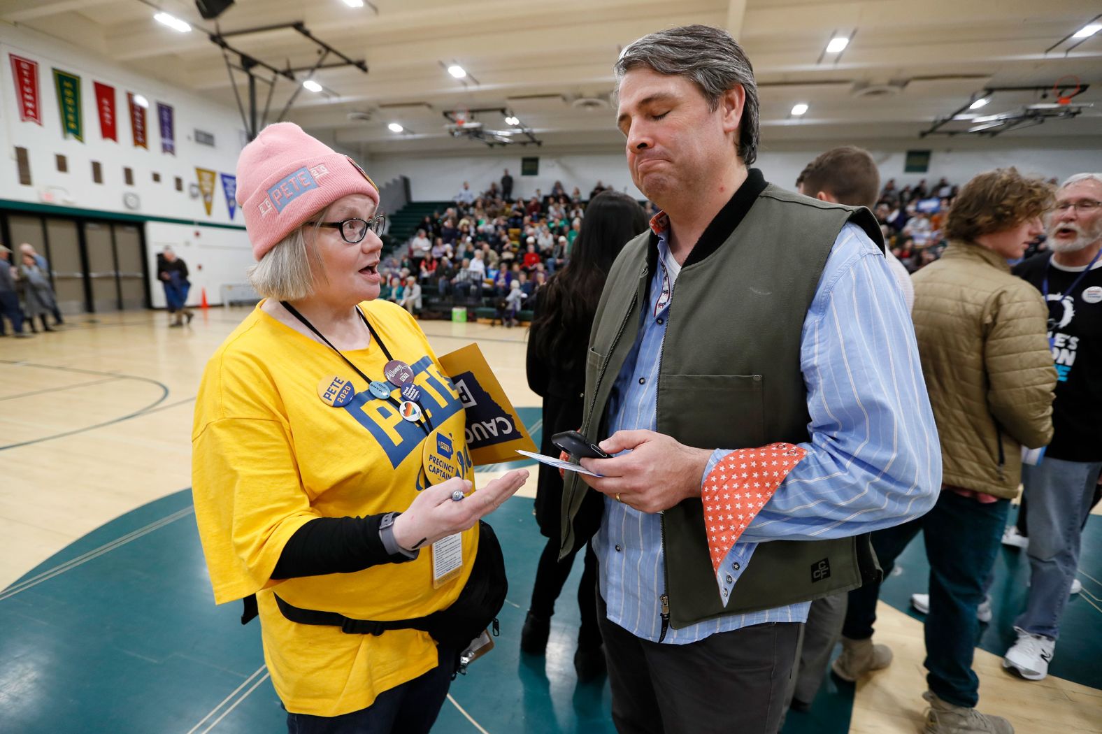 Elizabeth Hendrix, a precinct captain for Buttigieg, tries to persuade Tim Gannon to join her group at a caucus in Des Moines.