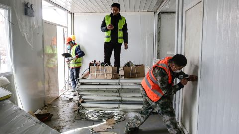 Workers pictured near the end of the 10-day contruction period for Huoshenshan Hospital.