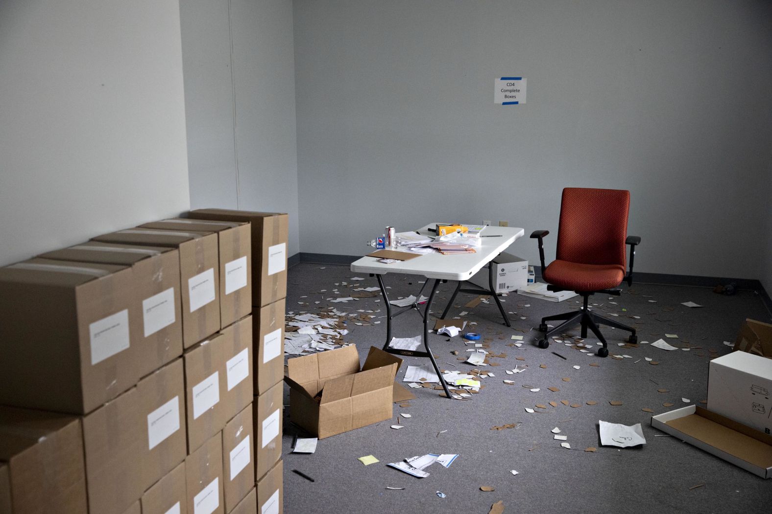 Papers cover the floor near boxes of voter registration forms inside an auxiliary Iowa Democratic Party office in Des Moines on Tuesday, February 4.