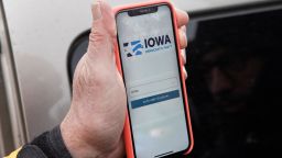 Precinct captain Carl Voss of Des Moines displays the Iowa Democratic Party caucus reporting app on his phone outside of the Iowa Democratic Party headquarters in Des Moines, Iowa, Tuesday, February 4, 2020. 