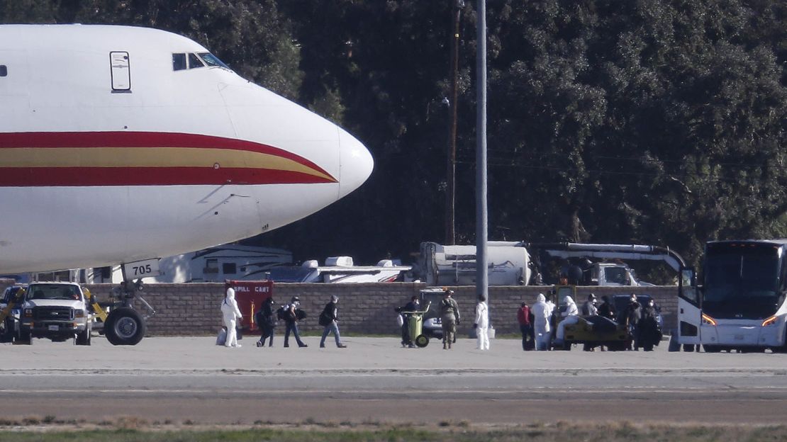 Passengers board buses after arriving January 29 on an airplane carrying U.S. citizens being evacuated from Wuhan, China, at March Air Reserve Base in Riverside, Calif. Under new restrictions, US citizens returning to the United States who have been in China's Hubei province in the two weeks before their return will be subject to up to 14 days of mandatory quarantine.