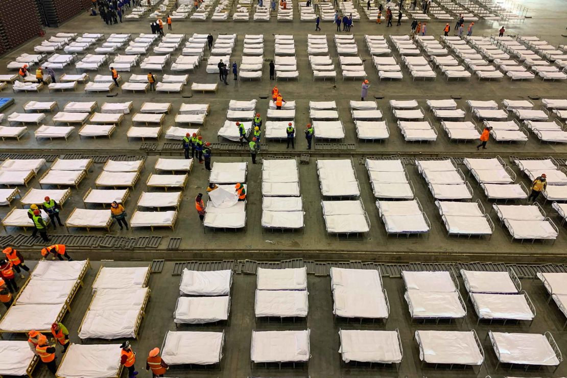 Workers set up beds at an exhibition centre that was converted into a "Fangcang hospital" in Wuhan on February 4.