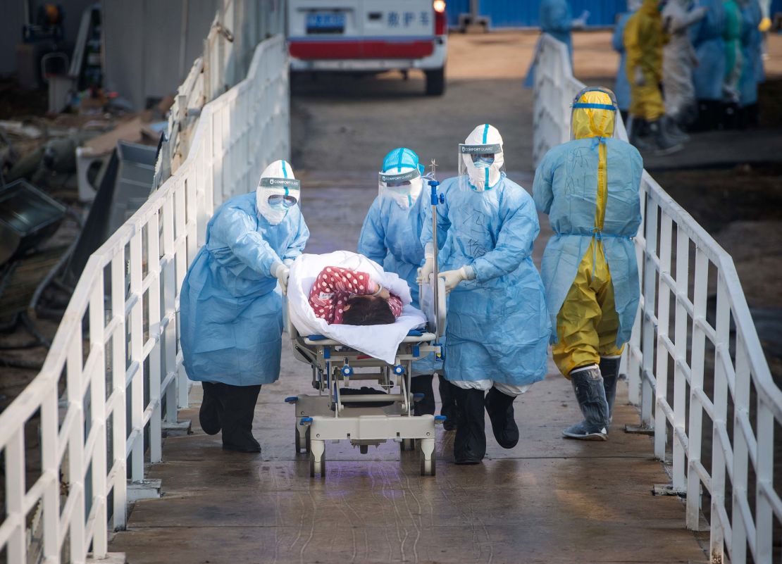 Medical workers move patients to the newly-completed Huoshenshan temporary field hospital in Wuhan. 