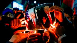 Palestinian protesters burn pictures of US President Donald Trump and Israeli Prime Minister Benjamin Netanyahu in Ramallah on January 28.