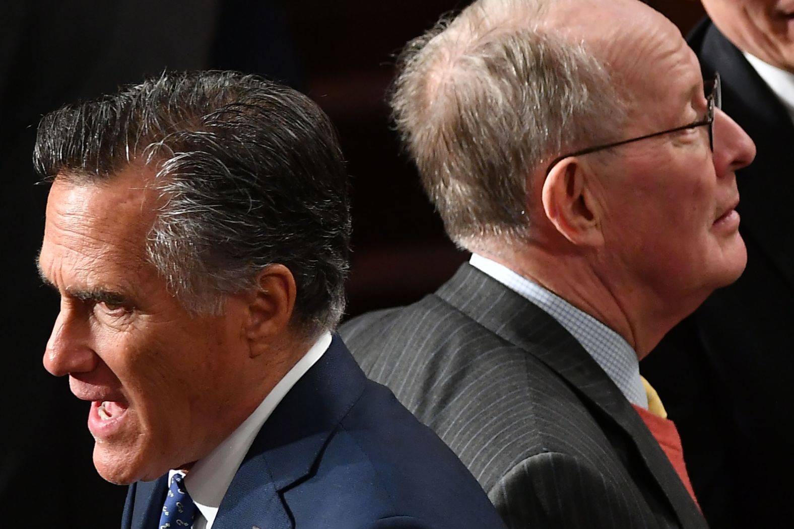 US Sens. Mitt Romney, left, and Lamar Alexander cross paths before the speech. Romney was one of two Republican senators who joined Democrats in voting to call new witnesses in Trump's impeachment trial. Alexander, a potential swing vote, voted against new witnesses.