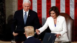 President Donald Trump hands copies of his speech to House Speaker Nancy Pelosi of Calif., and Vice President Mike Pence as he delivers his State of the Union address to a joint session of Congress on Capitol Hill in Washington, Tuesday, Feb. 4, 2020. (AP Photo/Patrick Semansky)