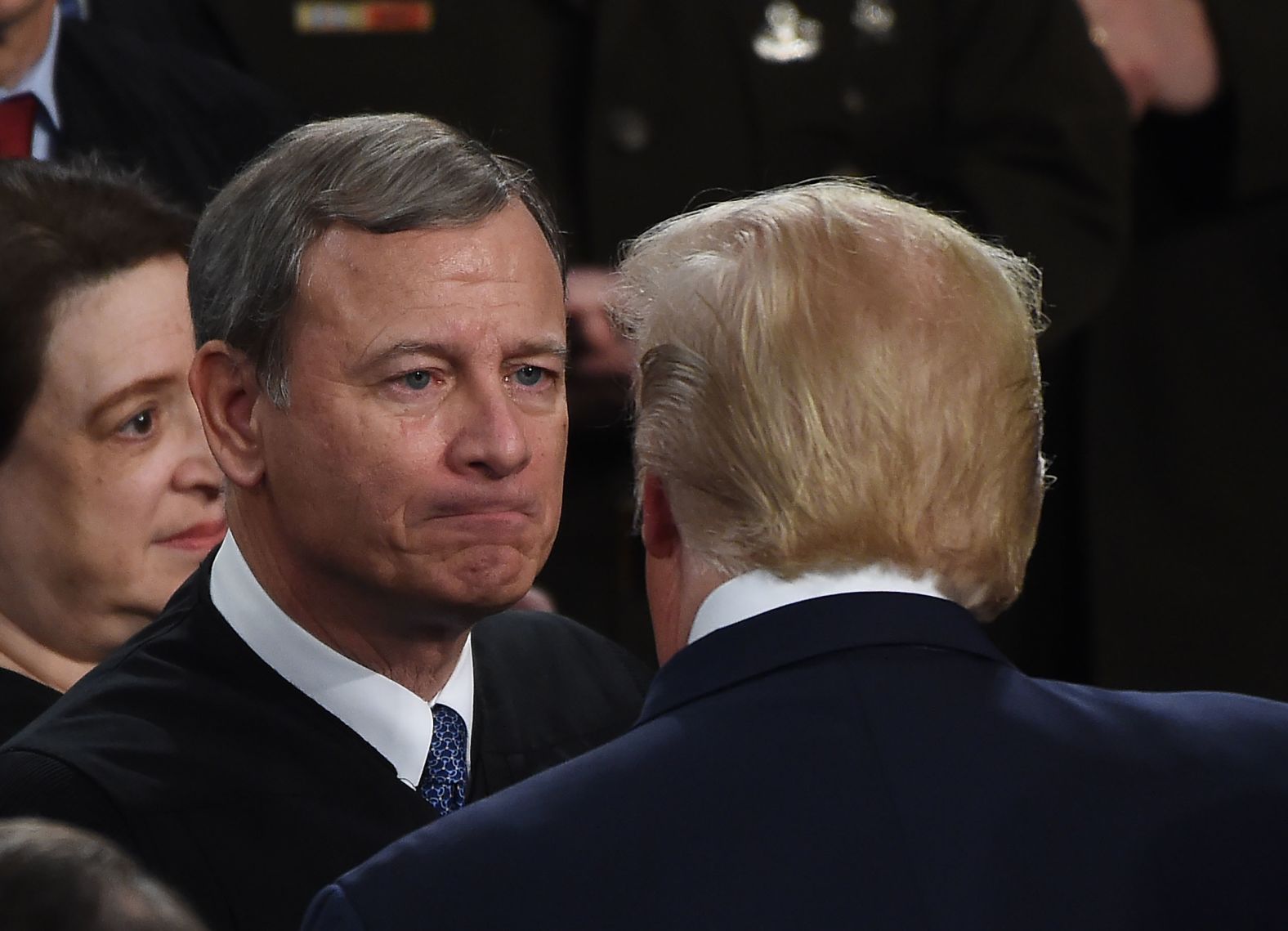 Trump greets Chief Justice John Roberts, who has recently spent hours in Congress presiding over the President's impeachment trial. Justices Neil Gorsuch, Brett Kavanaugh and Elena Kagan <a href="https://www.cnn.com/politics/live-news/state-of-the-union-2020/h_bc3ed3ca57467d7d5ca4438ae1a4d4c2" target="_blank">were also in attendance.</a>