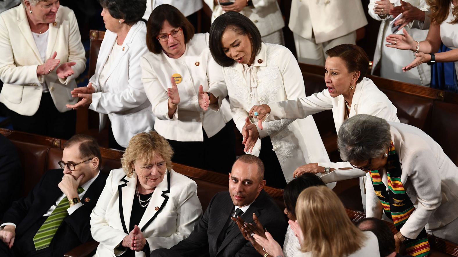 Democratic House members — including impeachment manager Hakeem Jeffries, bottom — gesture during the speech.