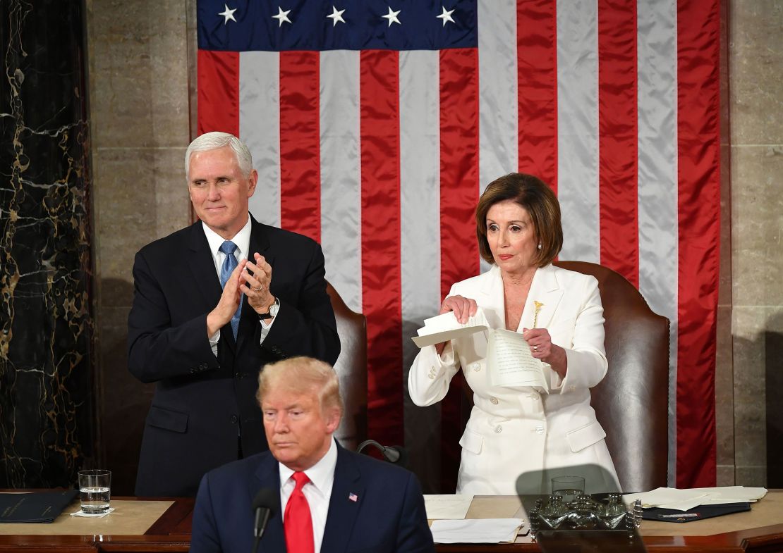 Vice President Mike Pence claps as Speaker of the US House of Representatives Nancy Pelosi rips a copy of President Trump's speech after he delivers the State of the Union address