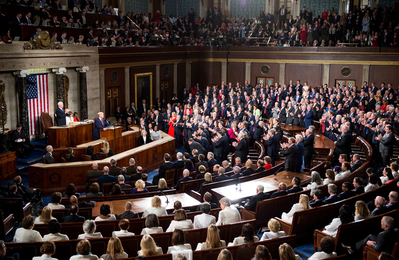 Republicans rise to applaud the President while Democrats stay seated.