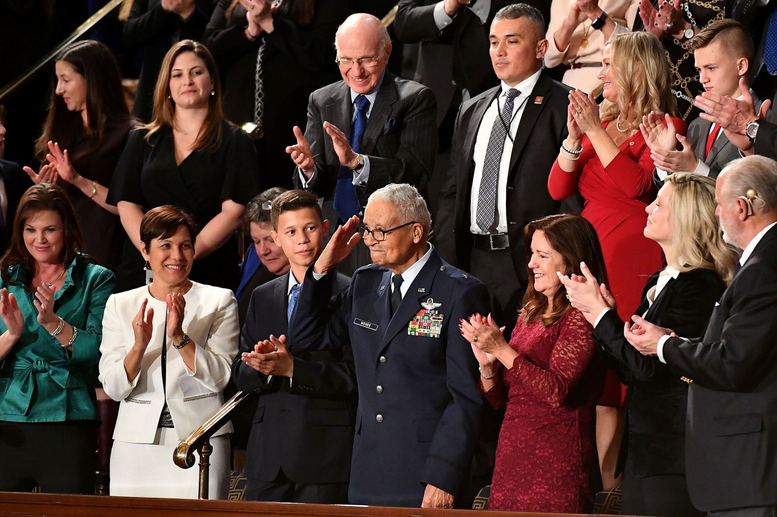 Retired Brig. Gen. Charles McGee, one of the Tuskegee Airmen, salutes as Trump acknowledges him and his great-grandson, Iain Lanphier. McGee is 100 years old.