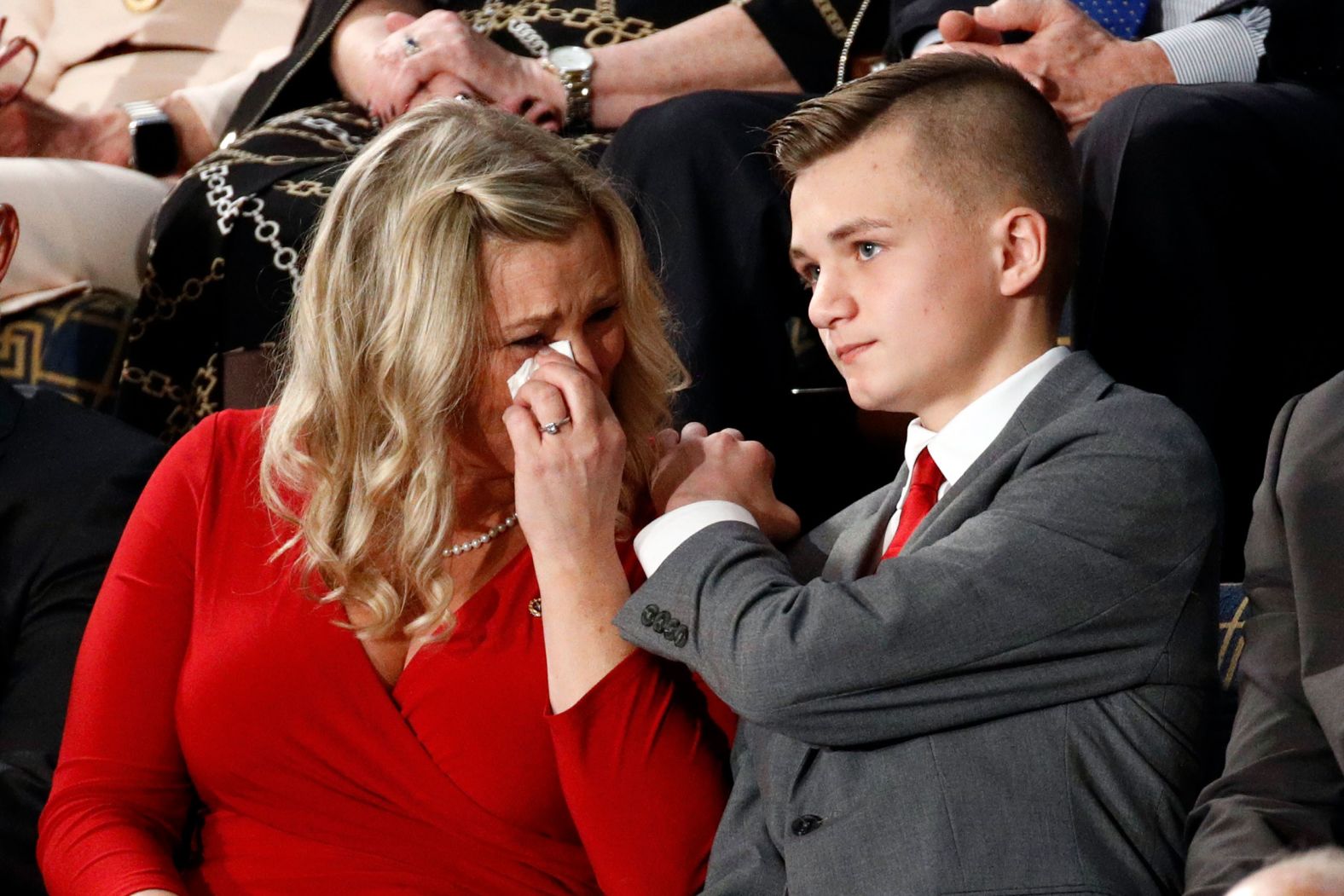 Kelli Hake cries as she and her son, Gage, are recognized by Trump during his speech. Army Staff Sgt. Christopher Hake, Kelli's husband and Gage's dad, was killed in 2008 while serving his second tour of duty in Iraq. The White House said Hake's vehicle was hit by a roadside bomb supplied by Iranian military leader Qasem Soleimani. Earlier this year at Trump's direction, Soleimani was killed in an airstrike.