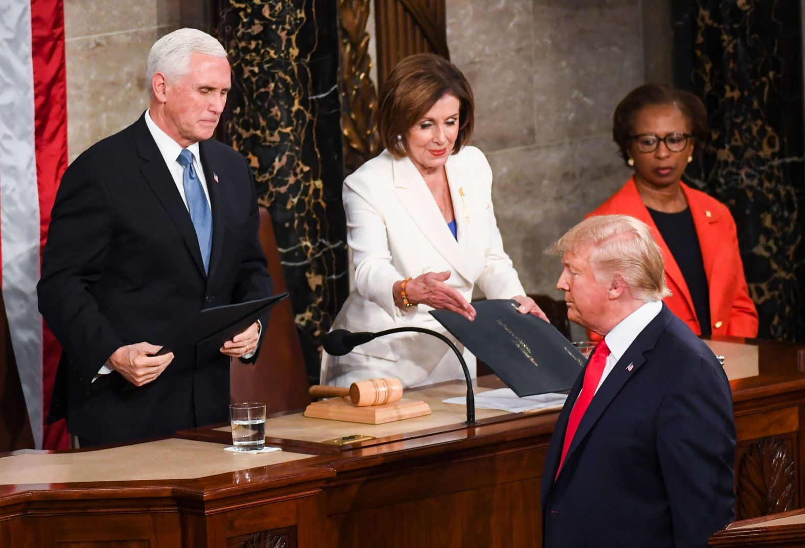 Pelosi reaches out to shake Trump's hand after being handed a copy of the speech. He turned away and left her hanging. The two haven't spoken in months.