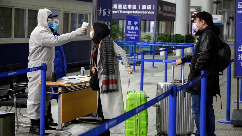 A security personnel checks the temperature of passengers arriving at the Shanghai Pudong International Airport in Shanghai on February 4, 2020. - The new coronavirus that emerged in a Chinese market at the end of last year has killed at least 425 people and spread around the world.
The latest figures from China show there are more than 20,400 people infected in the country. Outside mainland China, there have been more than 150 infections reported in around two dozen places. There have also been two deaths, in the Philippines and Hong Kong. (Photo by NOEL CELIS / AFP) (Photo by NOEL CELIS/AFP via Getty Images)