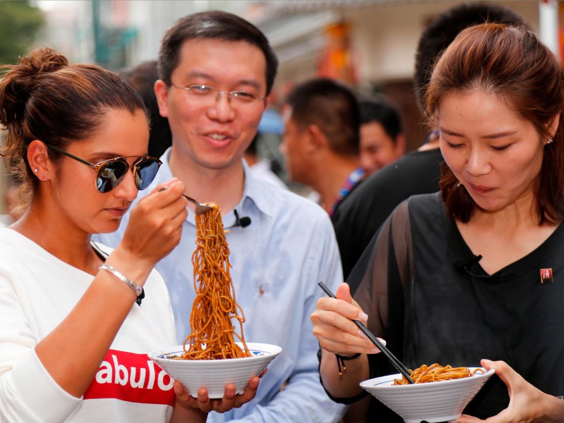 Sania Mirza of India and Li Na of China taste Wuhan noodles on September 25, 2017. 