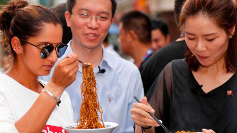 Sania Mirza of India and Li Na of China taste Wuhan noodles on September 25, 2017. 