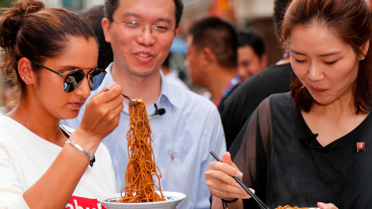 Sania Mirza of India and Li Na of China taste Wuhan noodles on September 25, 2017.