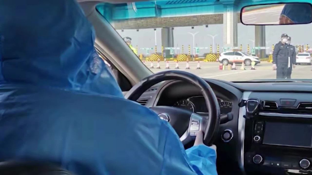 The taxi driver who picked up Priscilla Dickey and her daughter Hermione in Wuhan was wearing a blue protective suit.