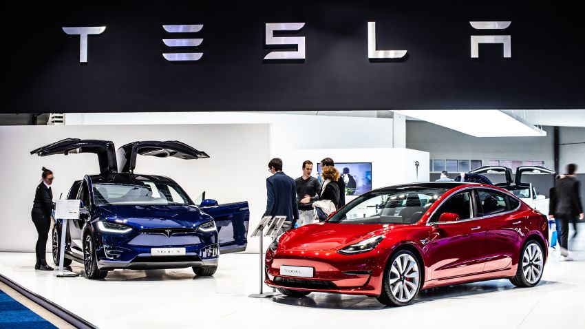 Brussels, Belgium, Jan 18, 2019: metallic red Tesla Model 3 and blue Tesla model X at Brussels Motor Show.